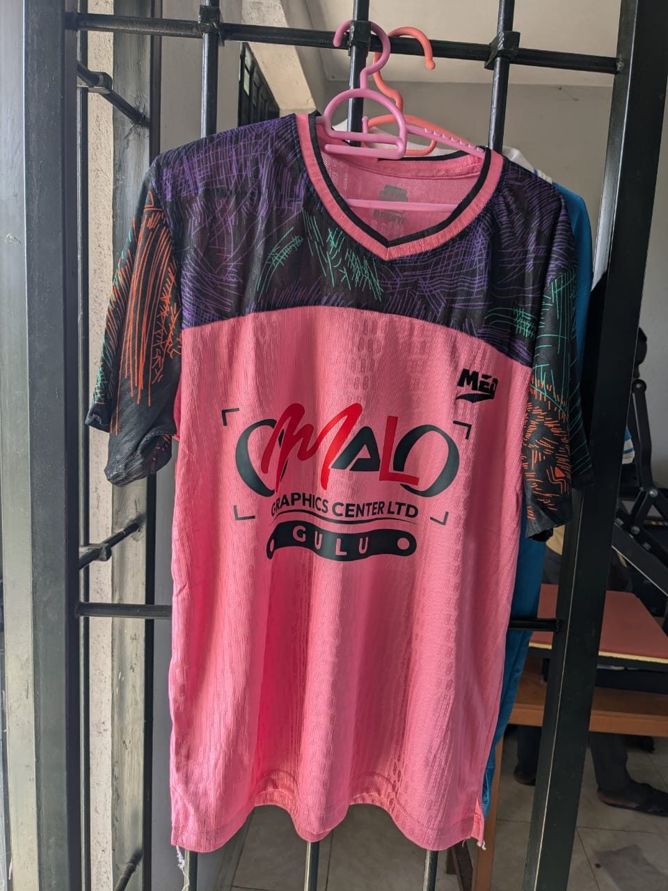 A sports jersey branded with the Omalo Graphics Centre Ltd logo, produced in our studio
