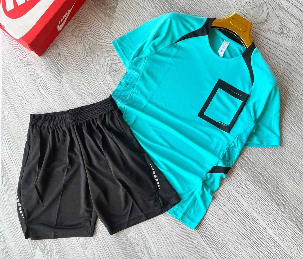 A teal sports jersey with black trim and matching black shorts, unbranded and ready for team logos