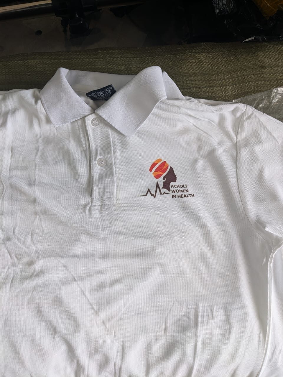 A branded polo shirt produced for Acholi Women In Health